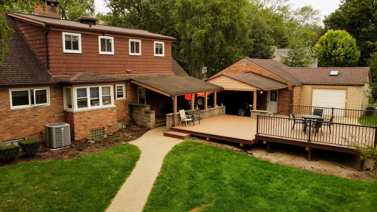 Aerial drone view of a home's backyard, deck, and patio
