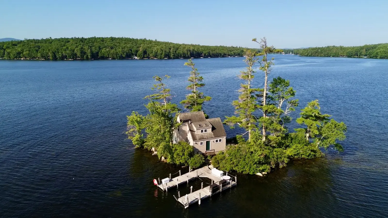 Aerial drone view of a private island home on a New England lake
