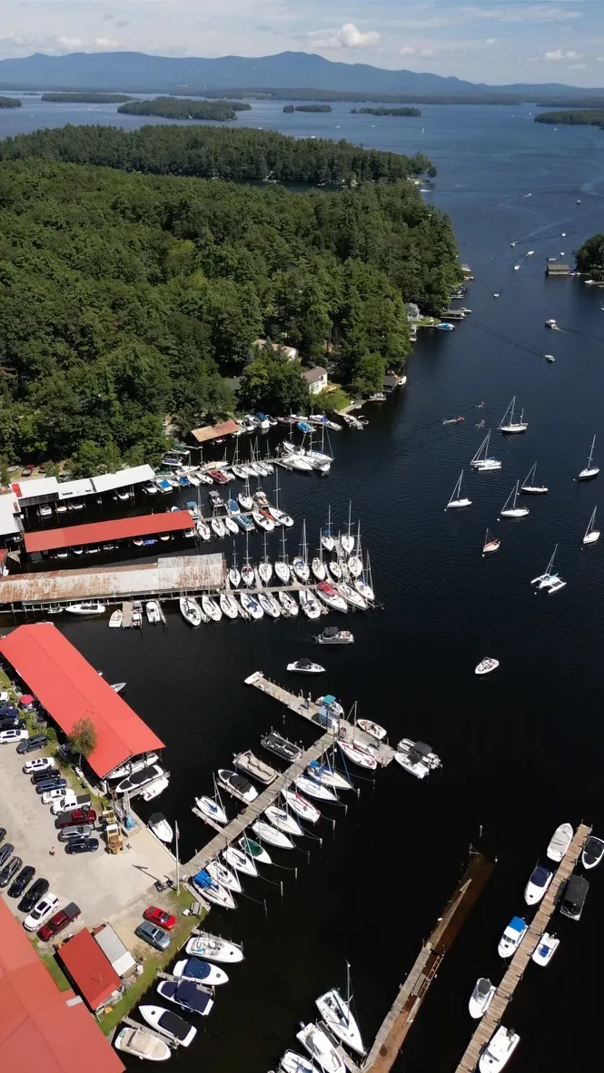 Aerial drone view of a marina with sailboats on a lake
