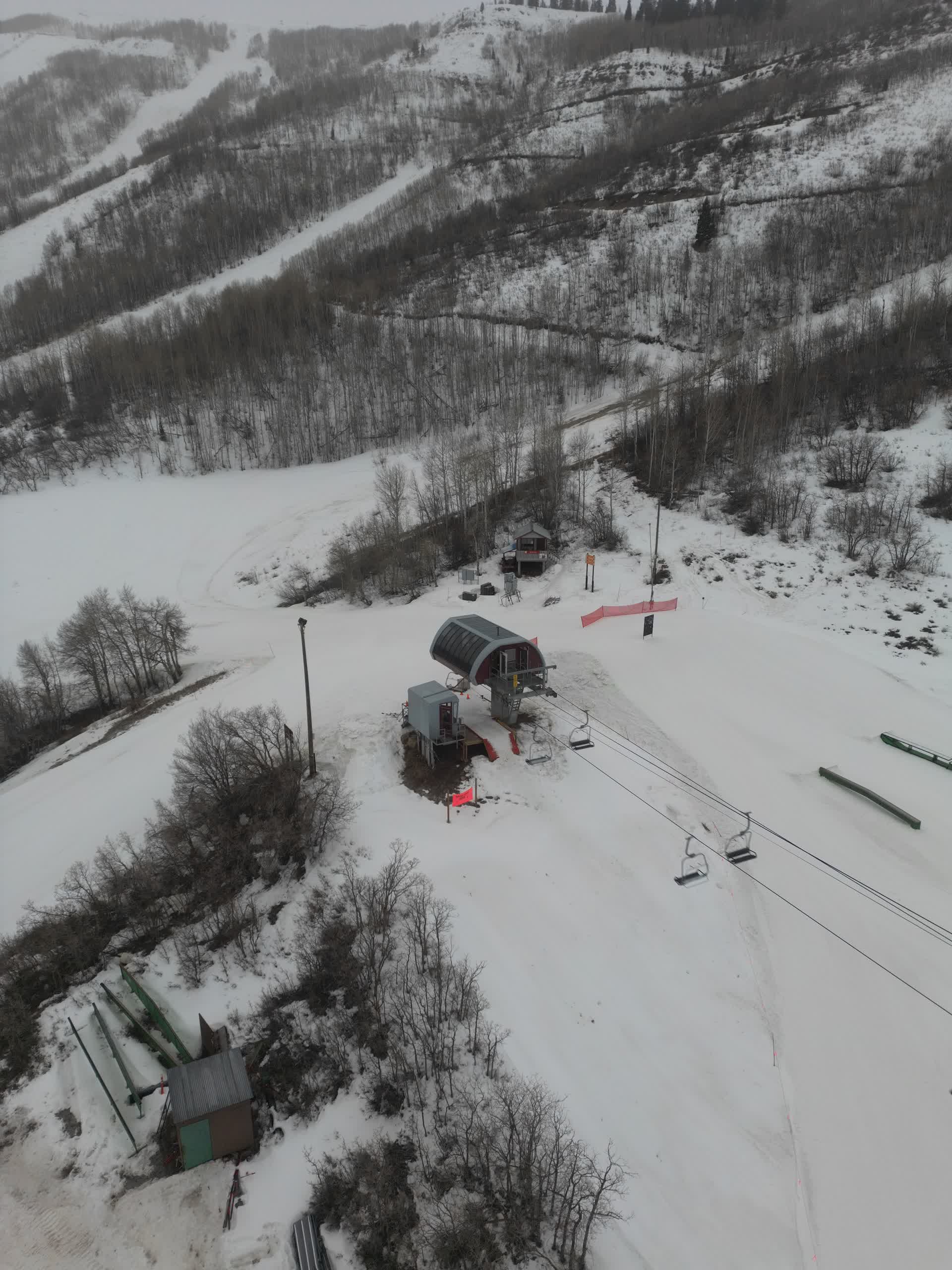 Aerial drone view of ski lift base station in winter